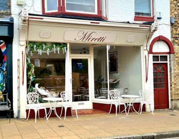 Exterior of Miretti Coffee Shop with outside seating.