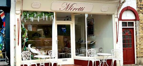 Exterior of Miretti Coffee Shop with outside seating.