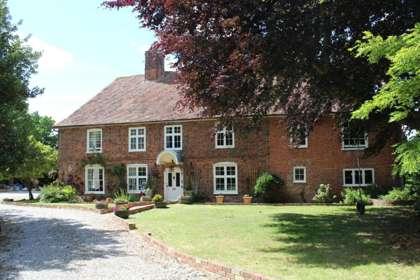 Front of Molland manor House with large Lawn in front.