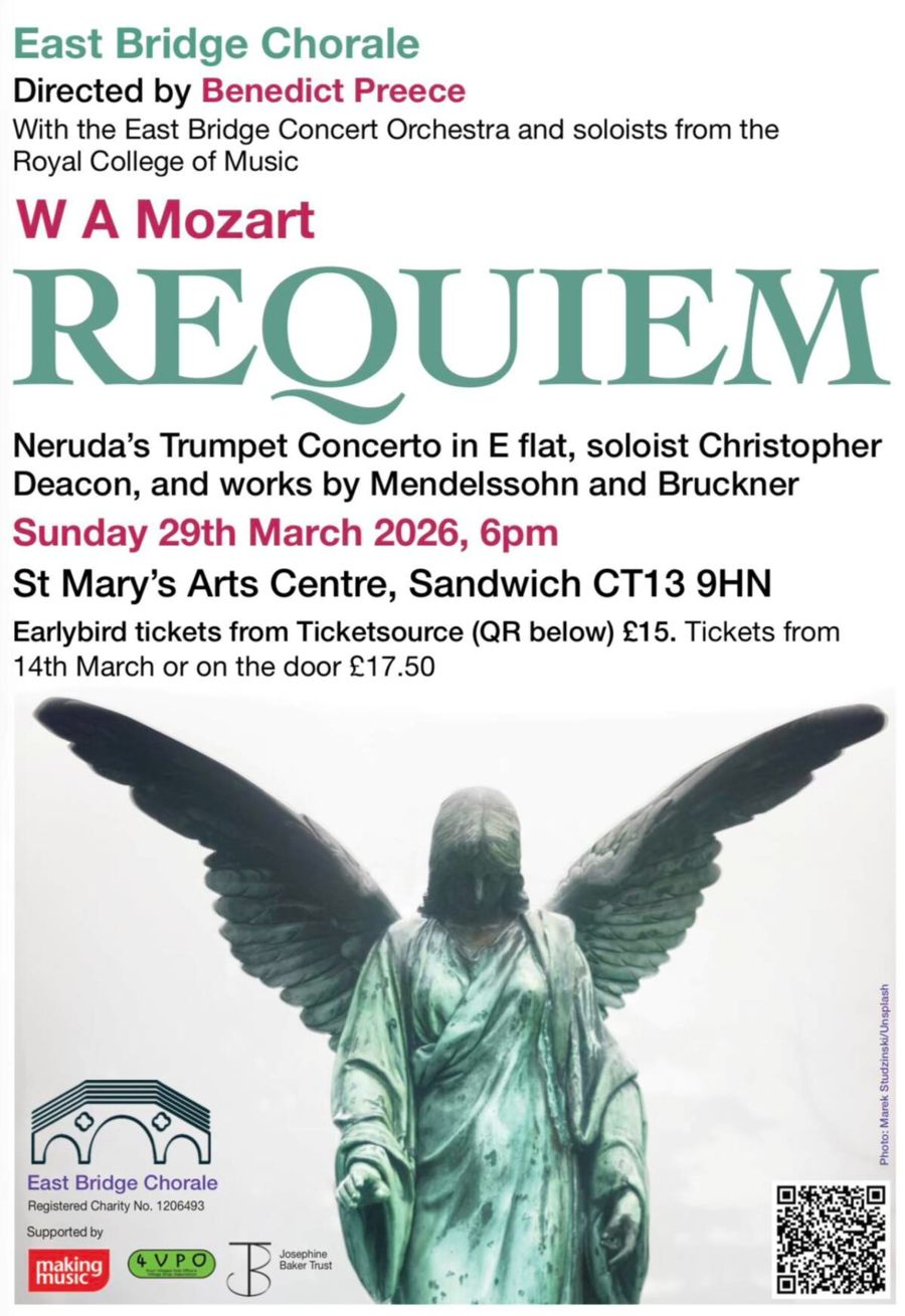 A statue of a greenish coloured angel with head bowed.