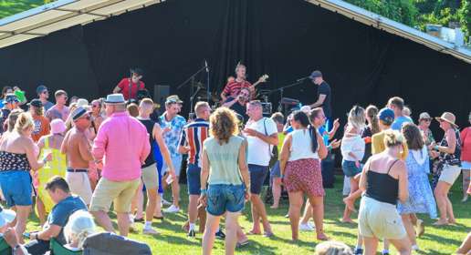 Band playing in front of an audience outdoors