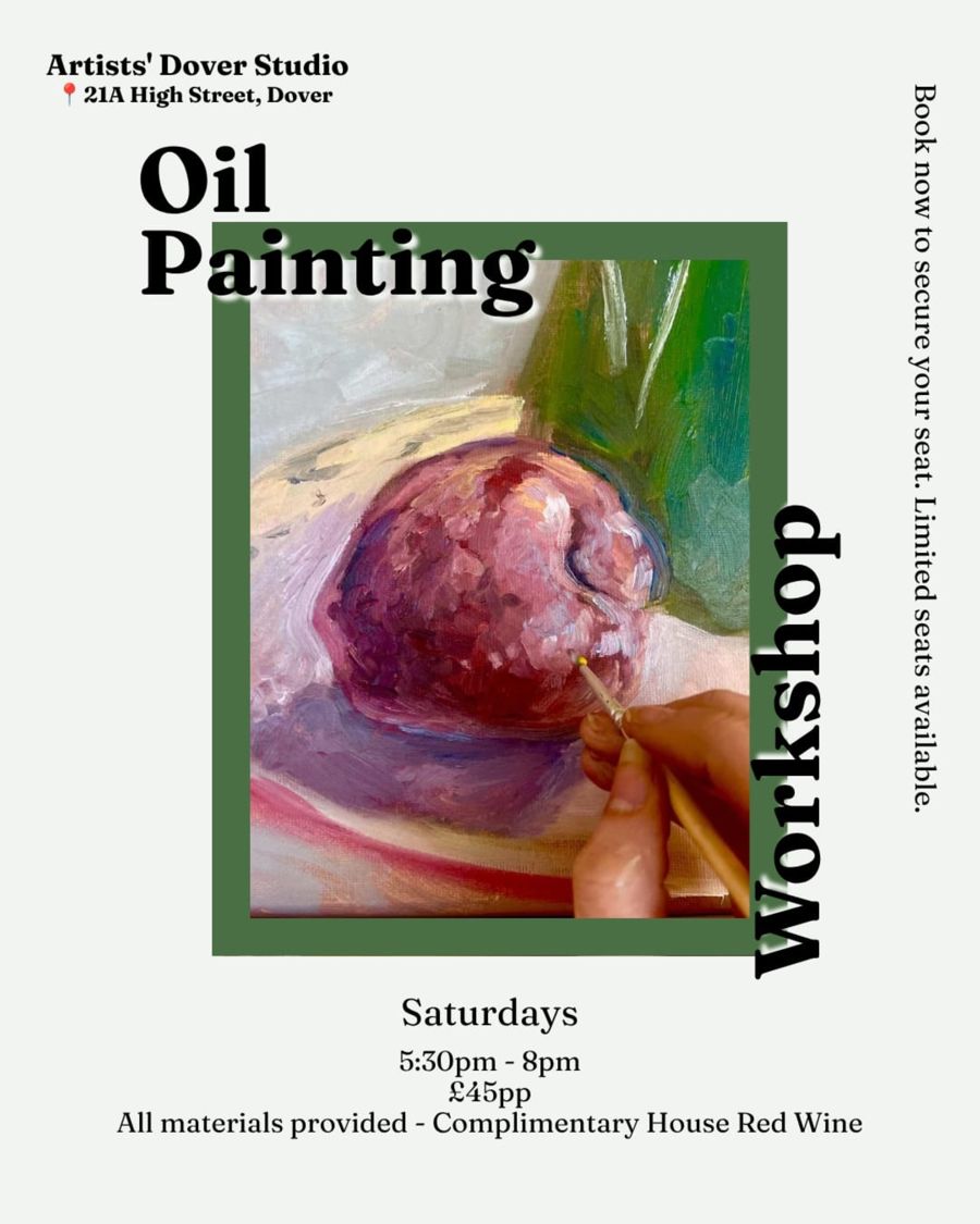 A hand with a paint brush painting an apple