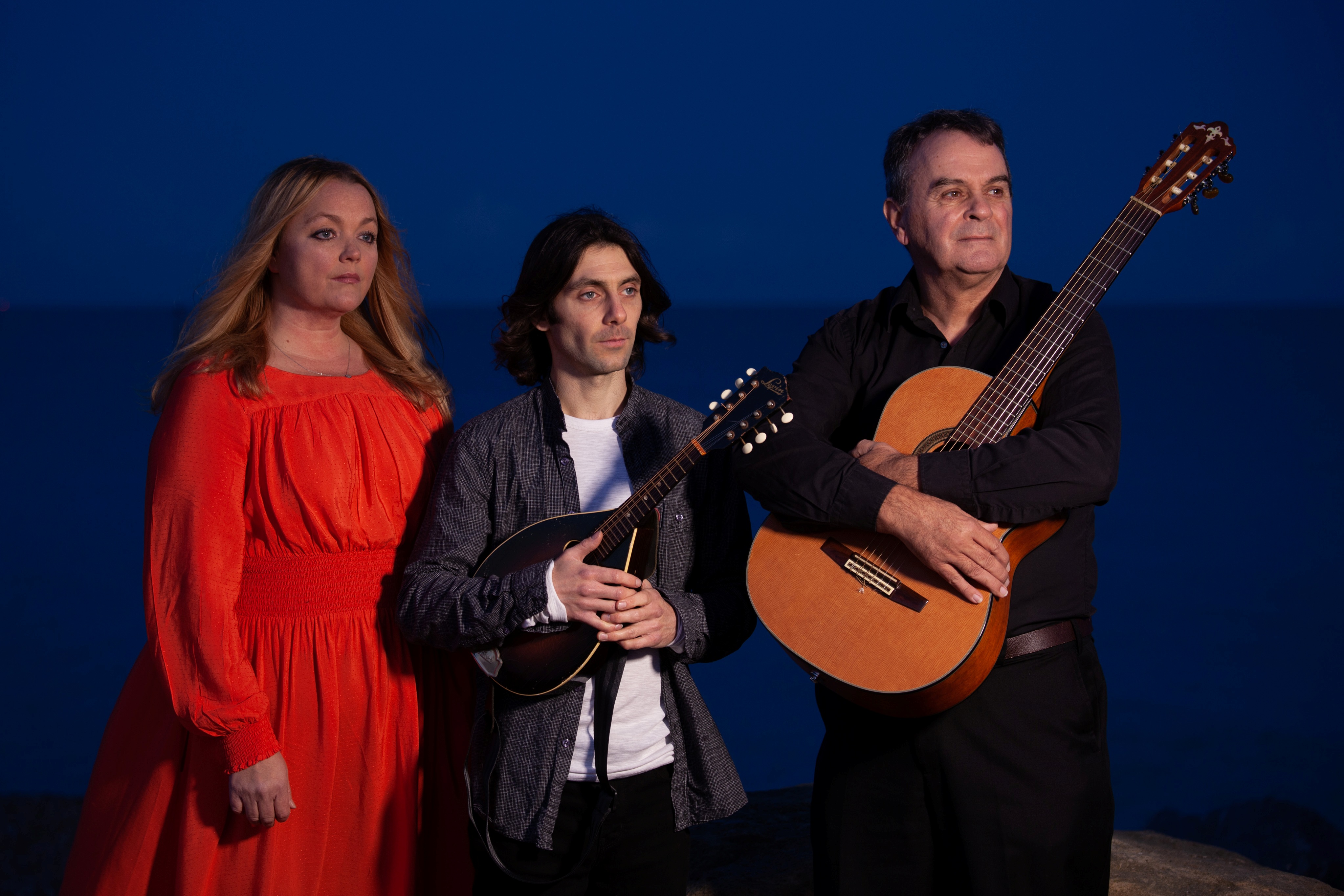 3 band members of Open Water holding their instruments