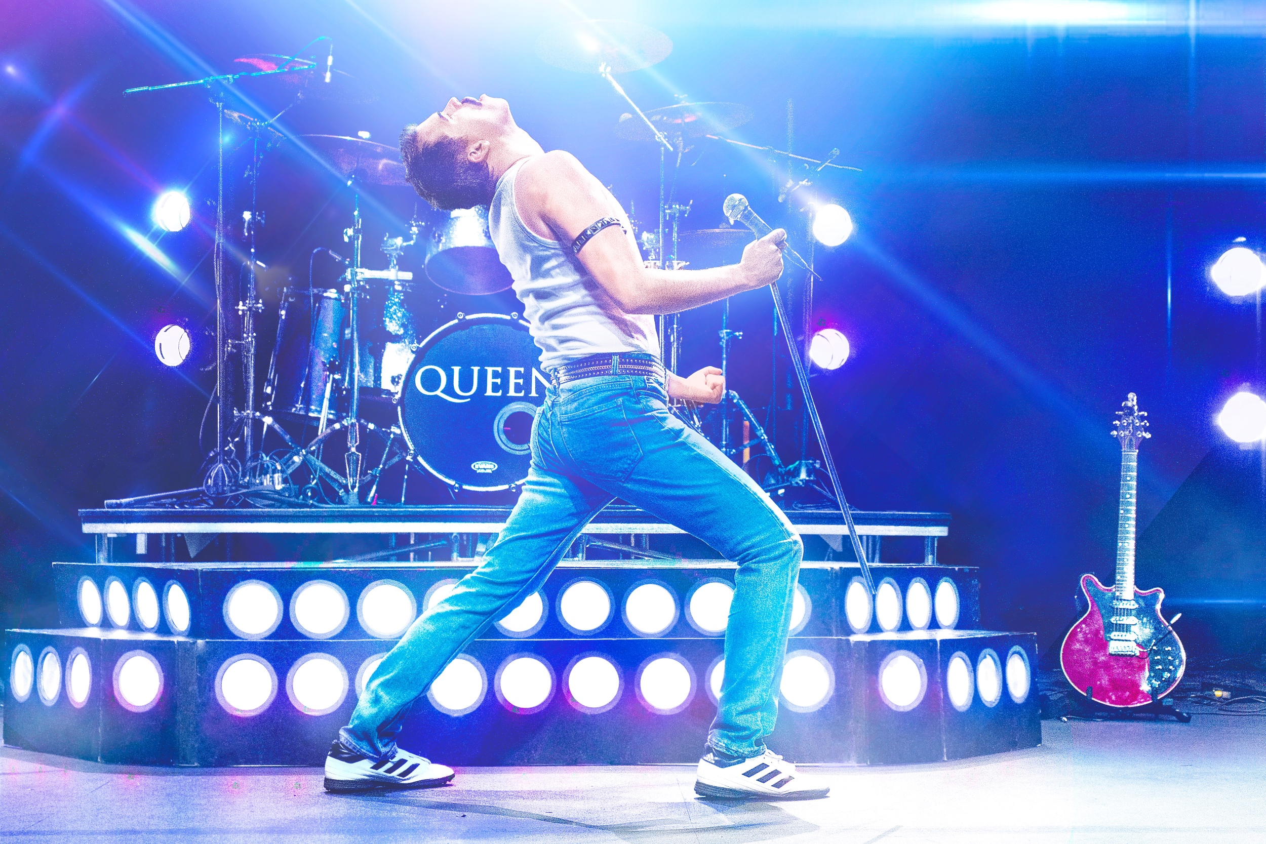 Freddie Mercury lookalike posing on stage