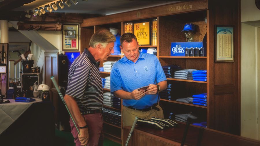 Two men looking at golf clubs