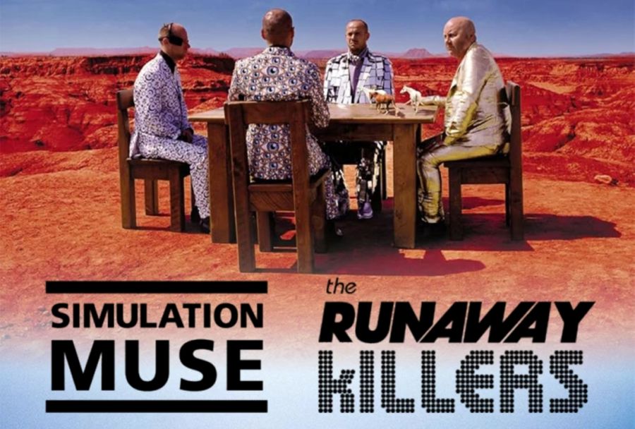 Four men in patterned suits sitting at a table in the desert 