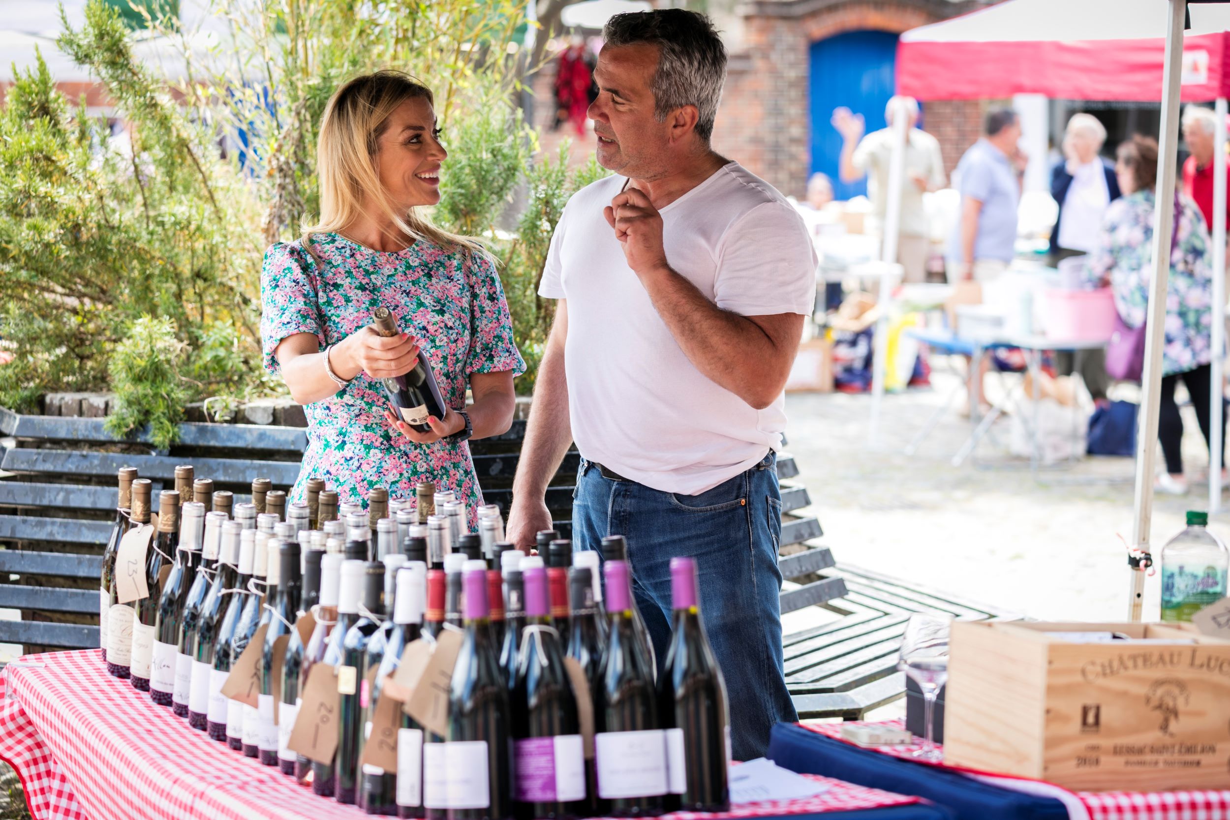 A market stall laden with wine bottles