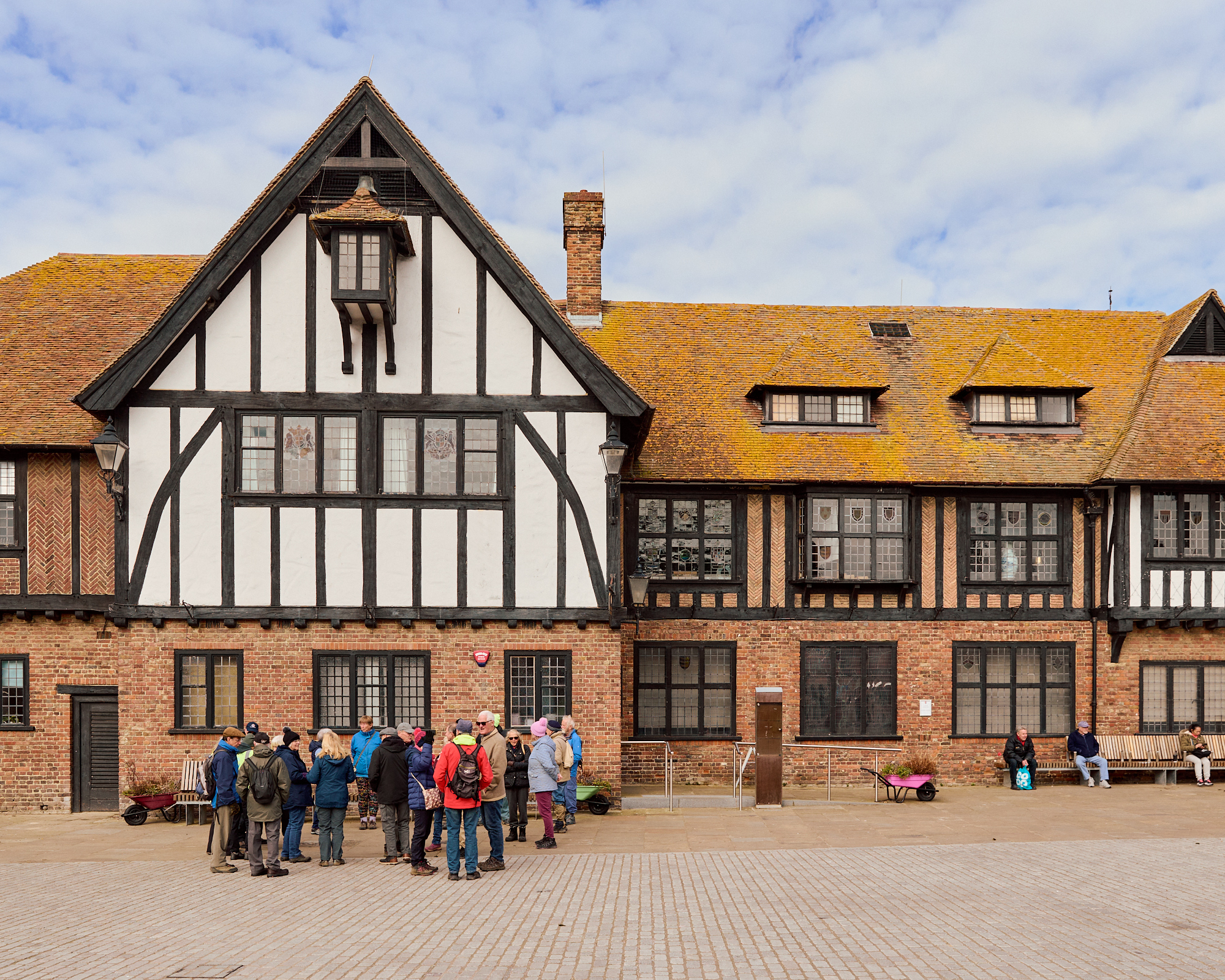 A group of walkers outside a Tudor building