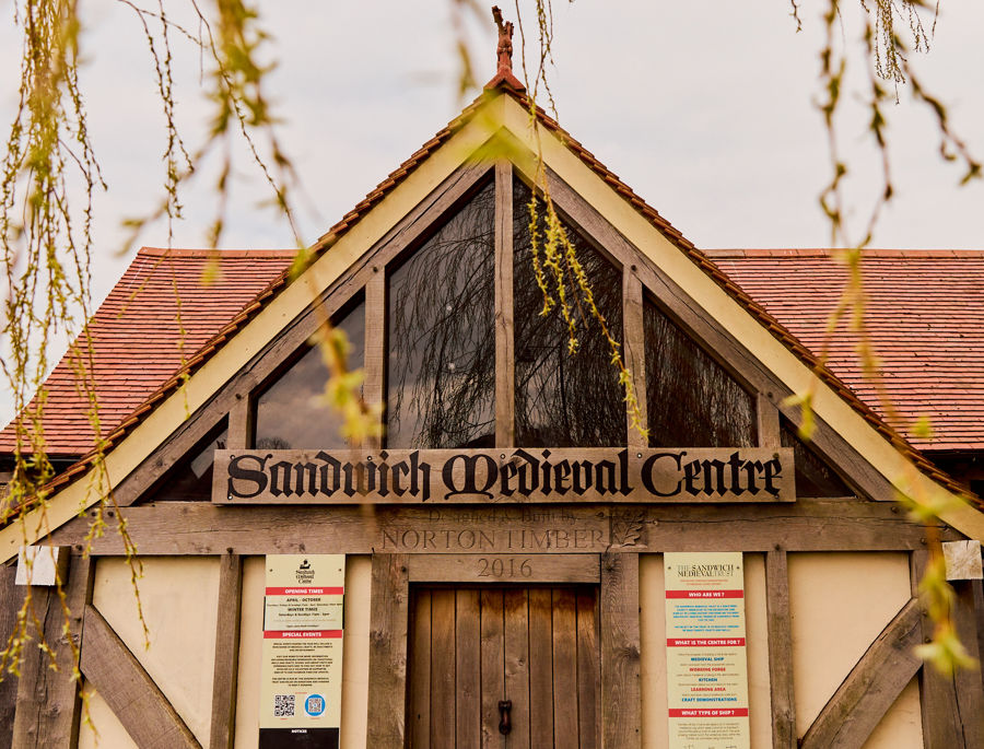A timber framed building with pointed roof.