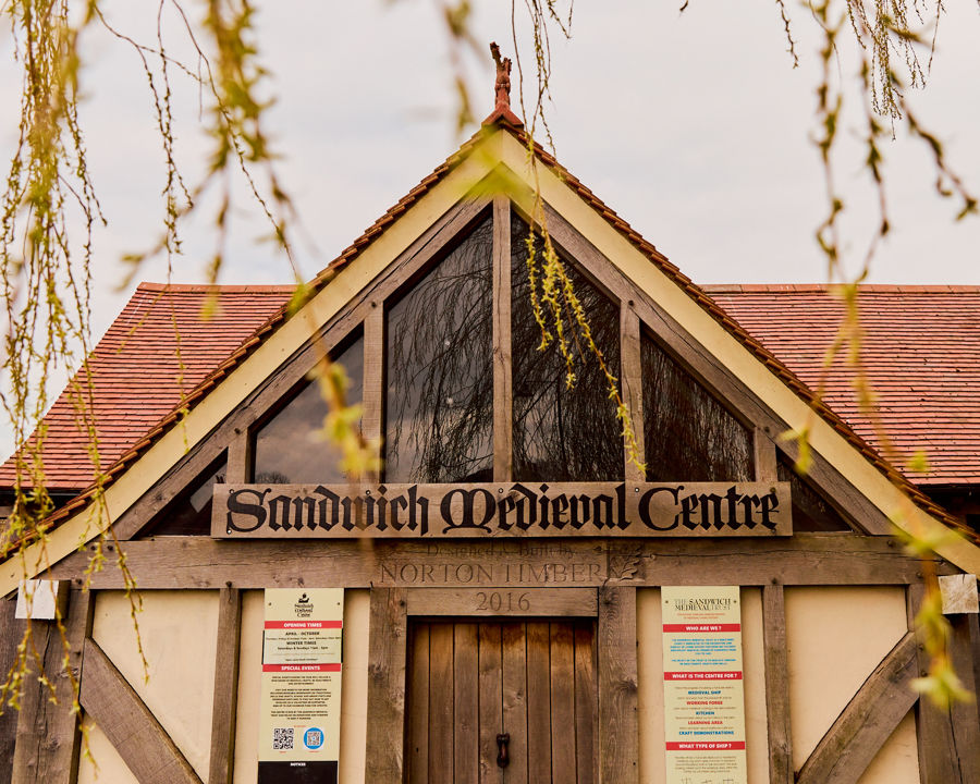 A timber framed building with pointed roof.