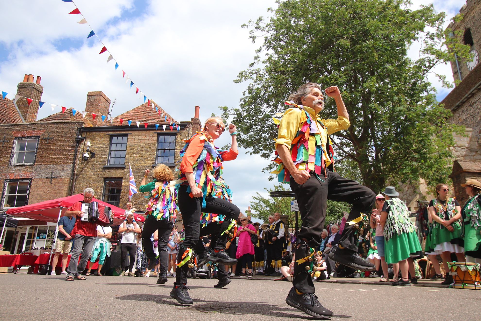 Morris dancers dancing in colourful clothes
