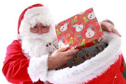Father Christmas offering a wrapped present from his sack