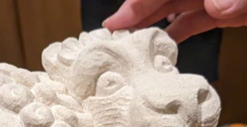 Hand touching gargoyle