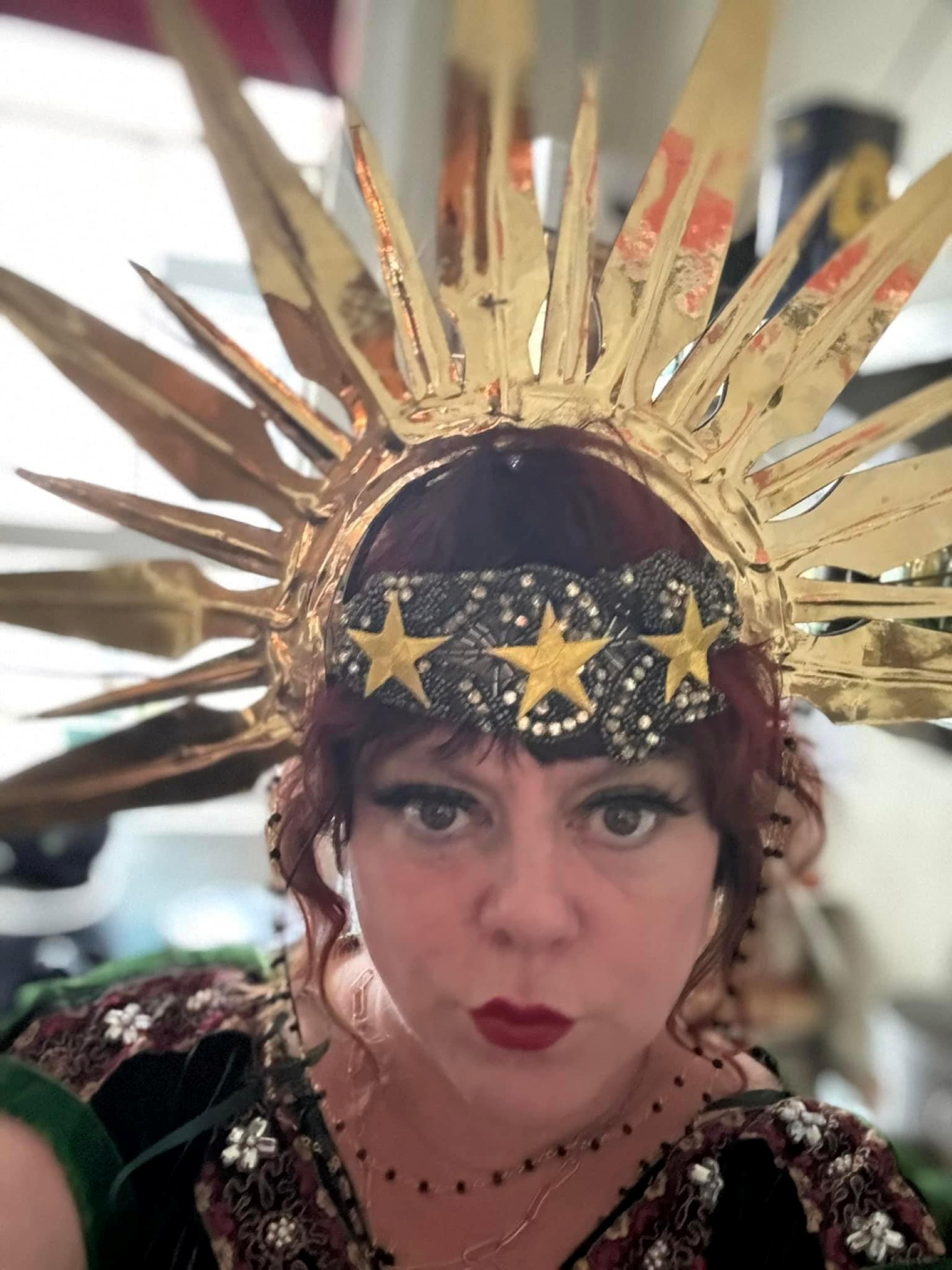 Celine's head with gold arrowhead headdress
