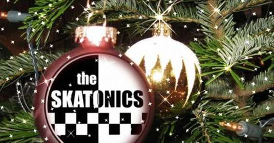Christmas bauble with the words The Skatonics in the middle hanging on a fir tree.