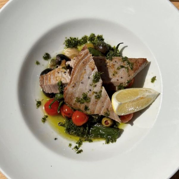 Tuna steak with padron peppers, roasted garlic, fresh cherry tomatoes, olives.