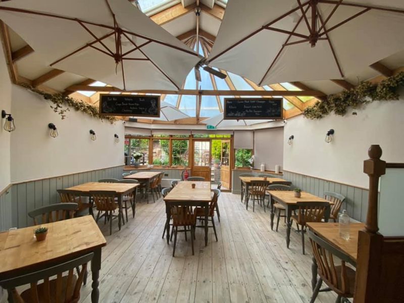 Interior showing tables & chairs in the conservatory area