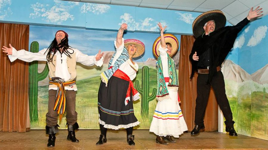 4 actors on stage singing