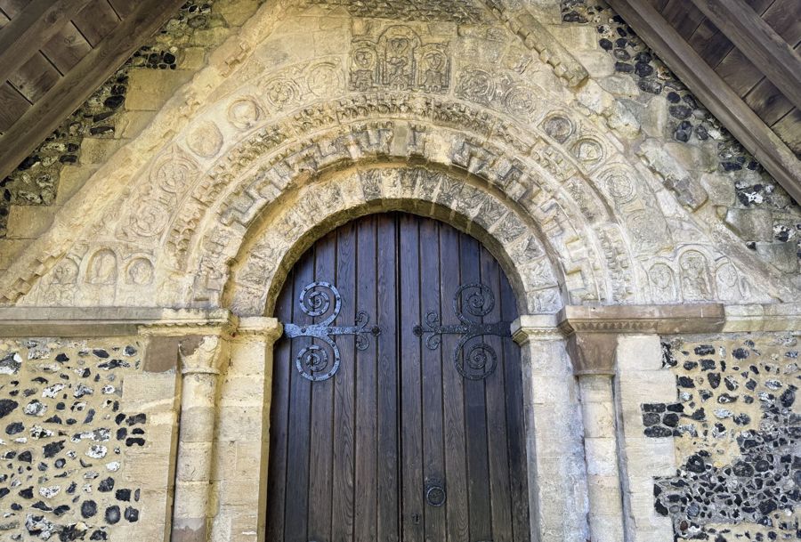 Carved stone archway above a wooden door.