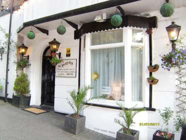 Front door of St Martins Guest House with ferns in pots