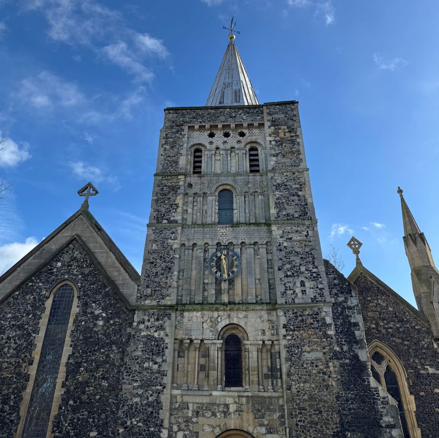 A church tower with spire and clock