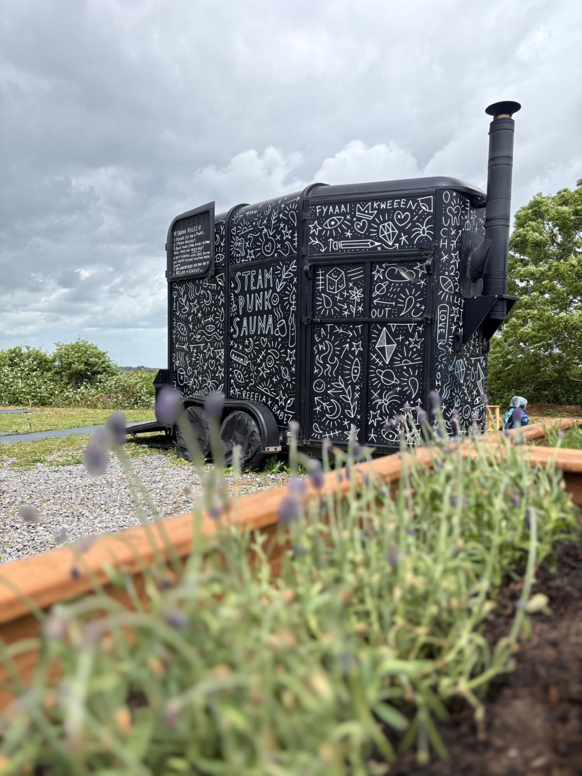 Converted horsebox decorated with white doodles on black