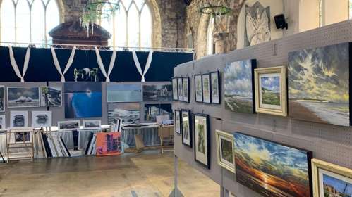Gallery space with paintings hung up