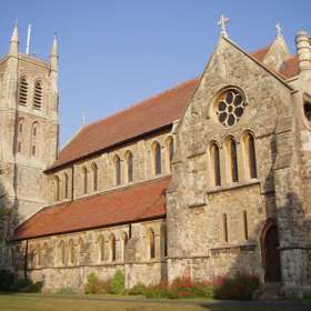 A stone church with painted glass mosaic windows
