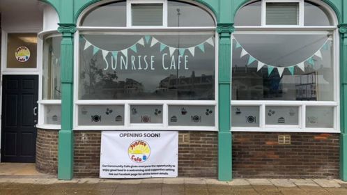 The frontage of the Sunrise Cafe in Dover with a sign saying 'opening soon'.
