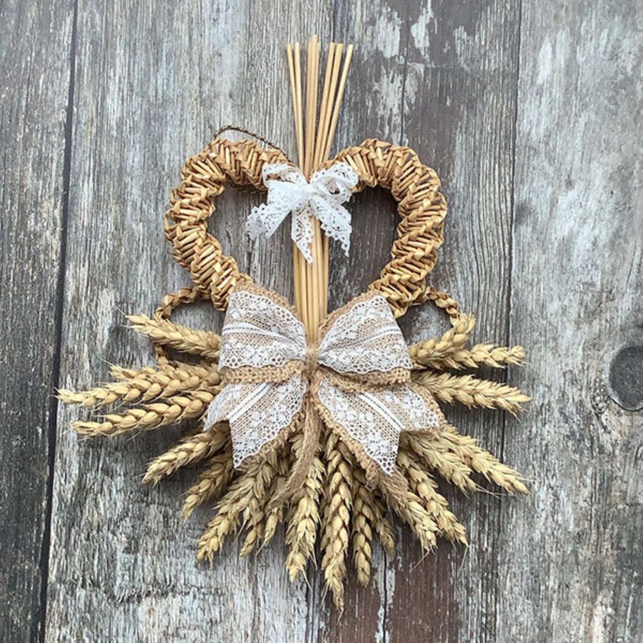 A heart made from woven wheat with decorative bow