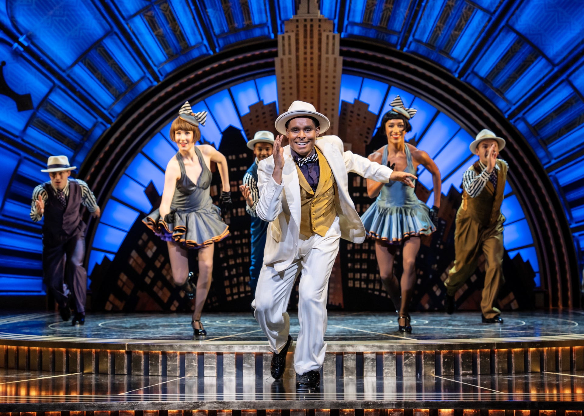 The cast of Top Hat performing on stage
