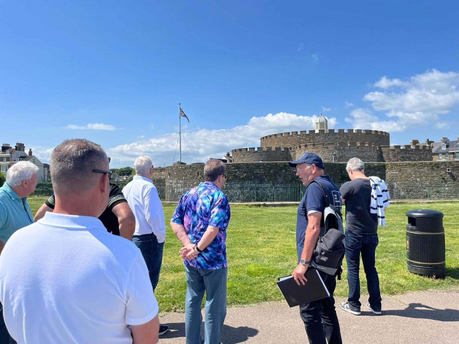 Group of men standing beside Deal Castle