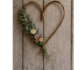 A heart shaped willow wreath with flowers