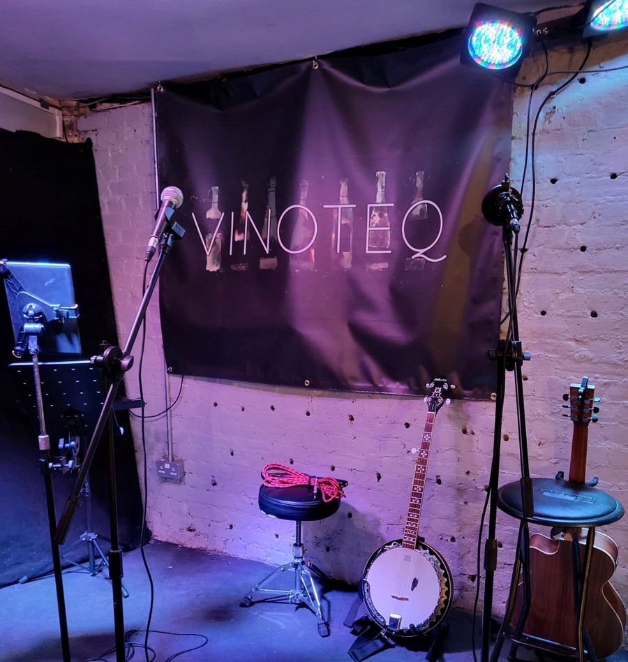 A stage set with microphones on stands and musical instruments