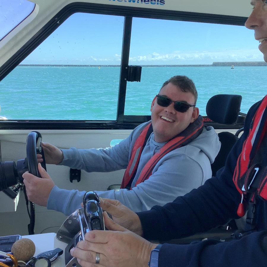 A passenger and skipper driving the Wetwheels South East boat in Dover Harbour.