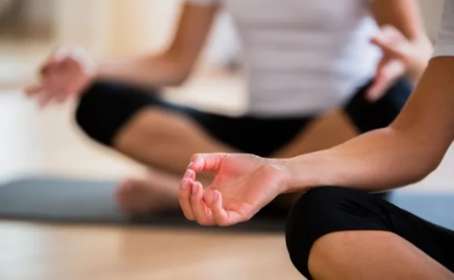 People sitting cross legged in yoga pose
