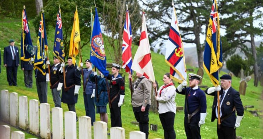 Standard bearers in front of military graves
