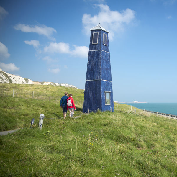 Couple walking on footpath towards Samphire Tower at Samphire Hoe